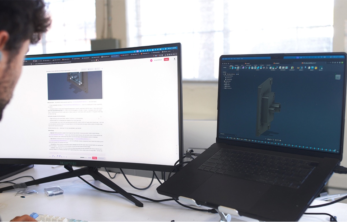 An engineer reviewing a CAD model alongside design notes